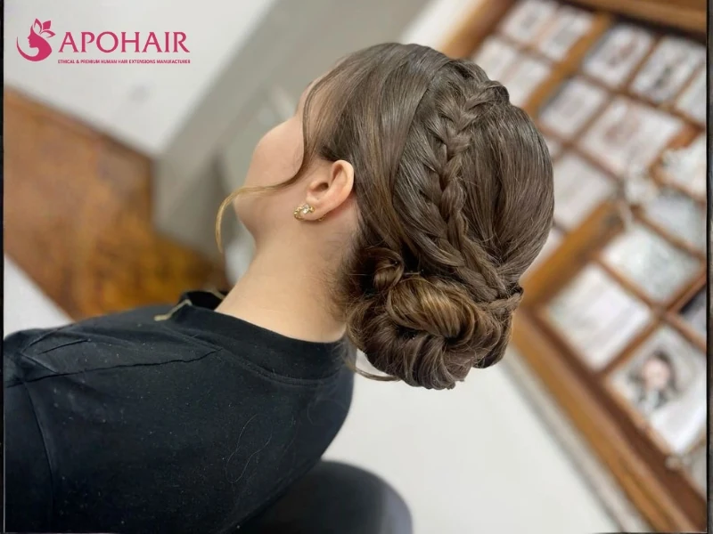 Long brown braid wrapped into a low bun viewed from behind