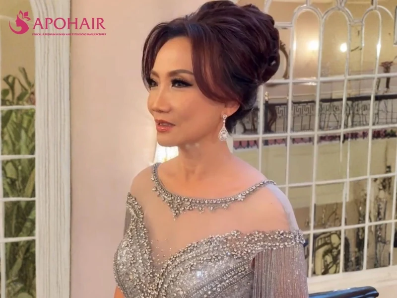 Elegant formal updo with swept-back crown volume and an embellished gown