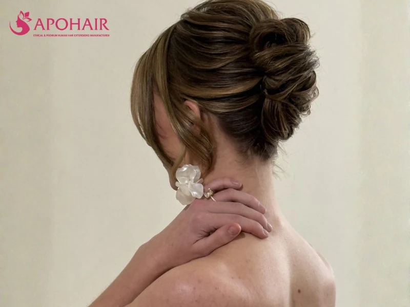 Brown hair swept into a vertical French twist with soft crown volume