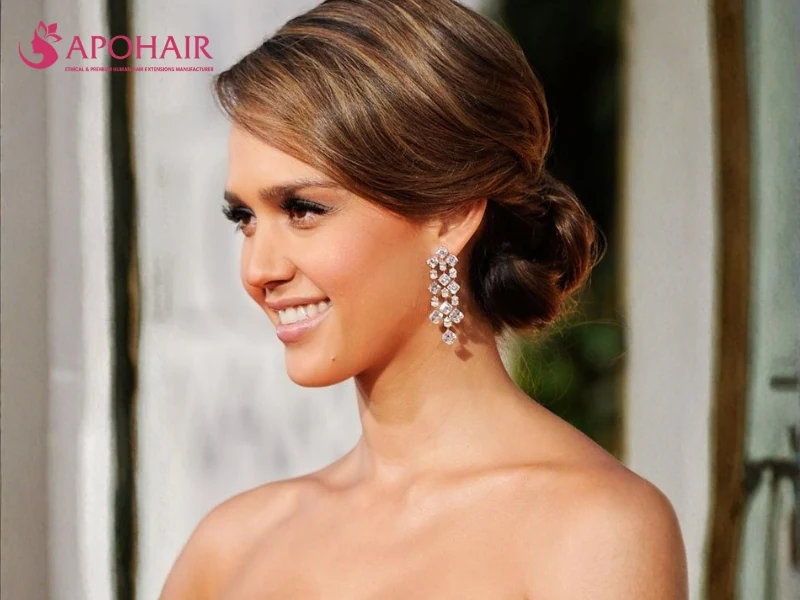 Side-parted brown hair gathered into a low side chignon
