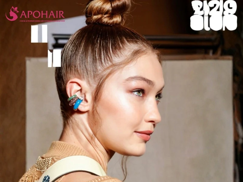 High twisted top knot with a smooth base and a curled face-framing strand
